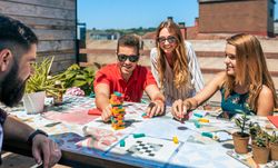 Group of office workers playing with game on terrace