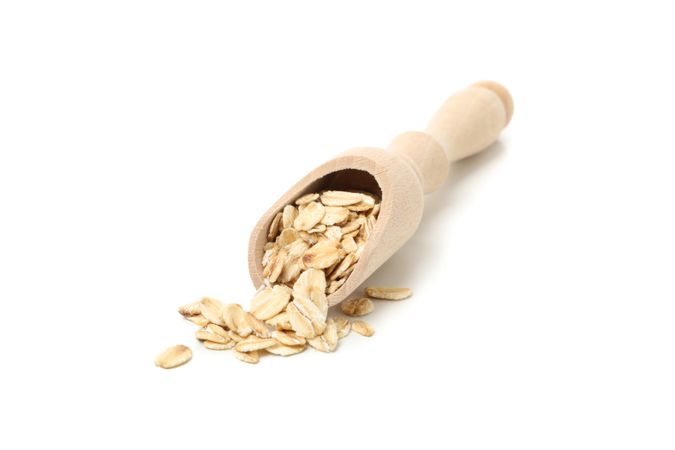 Scoop with oatmeal flakes isolated on plain background