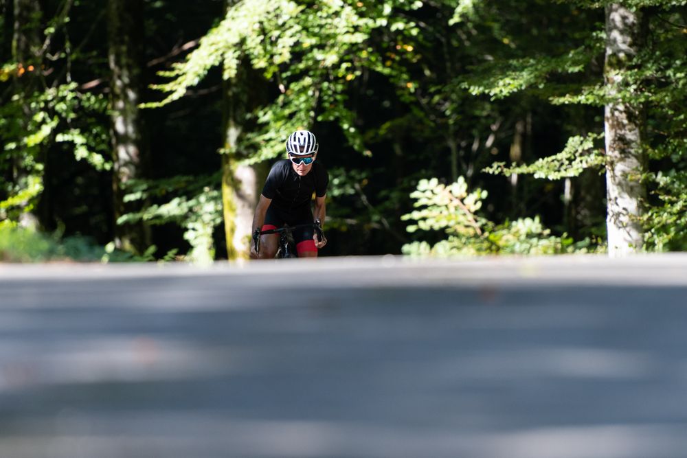 Professional cyclist riding bike in park