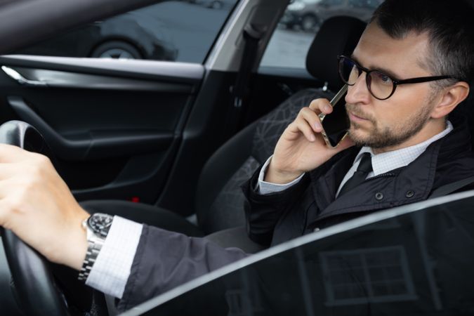 Businessman Driving and Talking on Phone