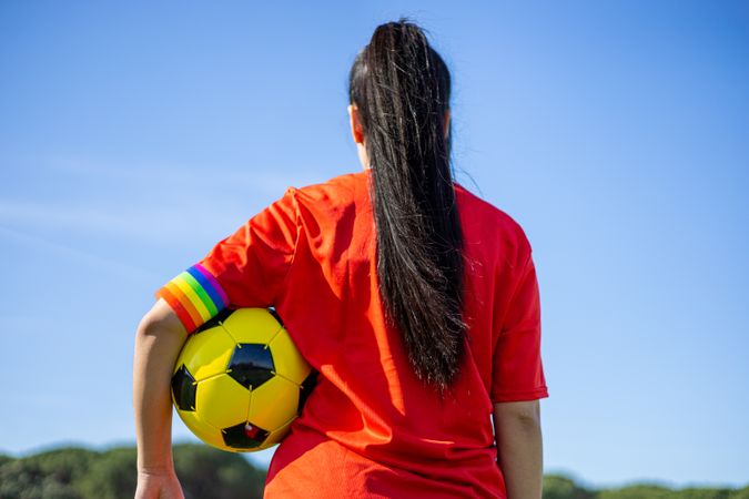 Female soccer player with rainbow armband
