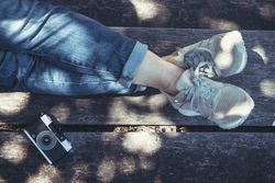 Woman sitting on bench with crossed legs