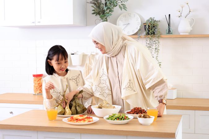 Mom and Daughter Preparing Ketupat Lebaran for Eid Al Fitr Celebration at Home