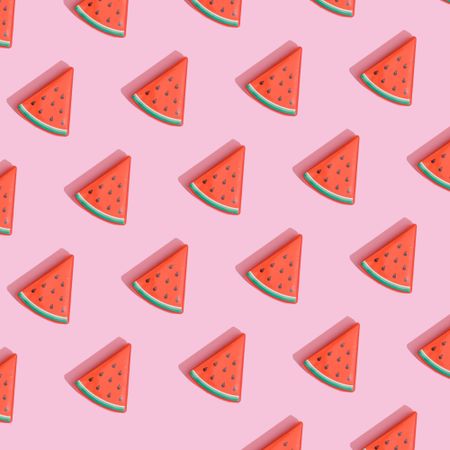Pattern of watermelon slices on pastel pink background