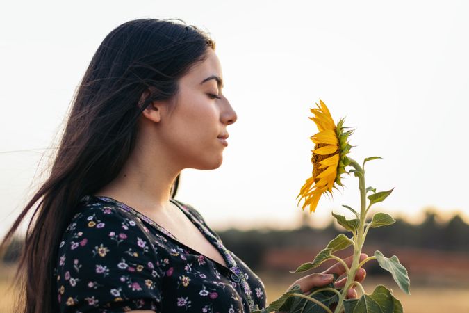 Portrait of a young woman with long hair in the countryside