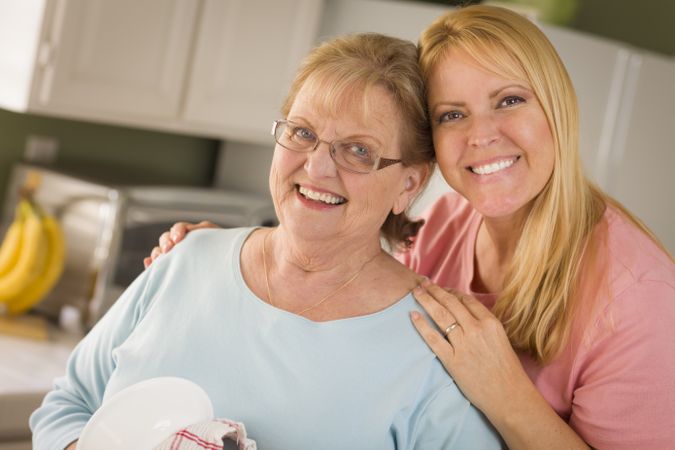 Older Adult Woman and Young Daughter Portrait in Kitchen