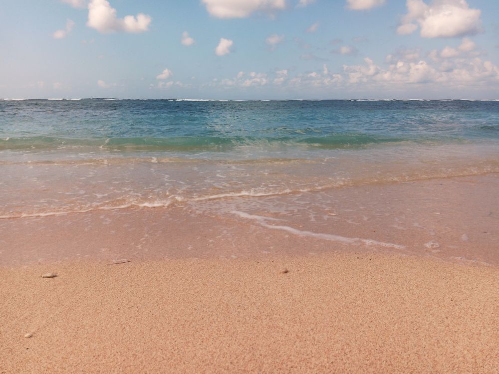 Beautiful sand beach with clear bluish sea water