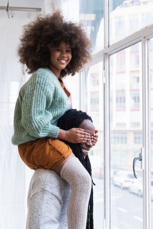 Black girl playing game with father and laughing happily