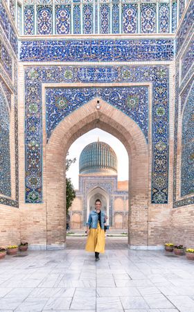 Female tourist in entrance of ornamental building