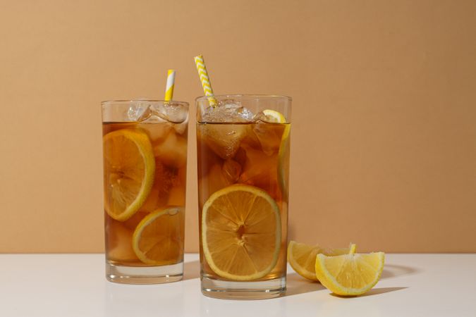 Glasses of cold tea with an orange