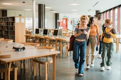 Diverse students leaving library together