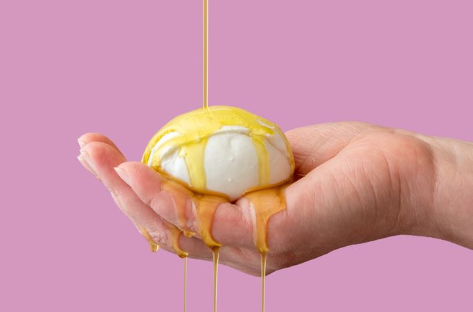 Mozzarella cheese with olive oil in woman hand