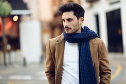 Portrait of man in light winter clothes walking outside