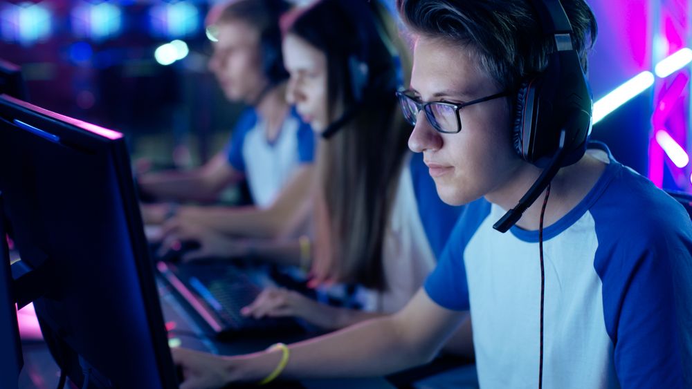 Professional Gamer Plays in Video Game on a eSports Tournament/ Internet Cafe.