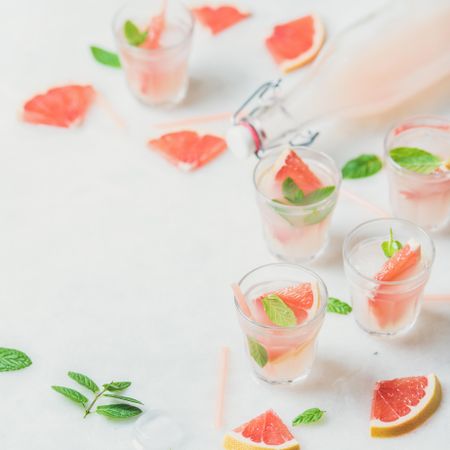 Flat-lay of cold refreshing summer alcohol cocktail with fresh grapefruit