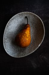 Sweet organic pear fruit in grey bowl