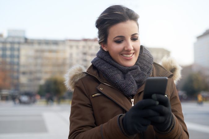 Young woman using smart phone outdoors