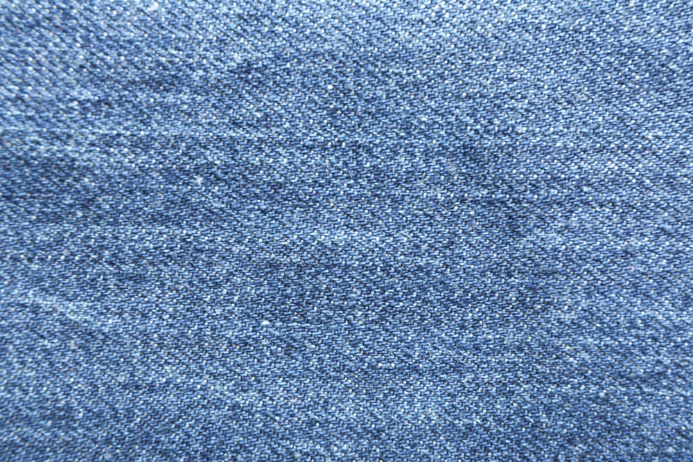 Texture of blue jeans as background, space for text