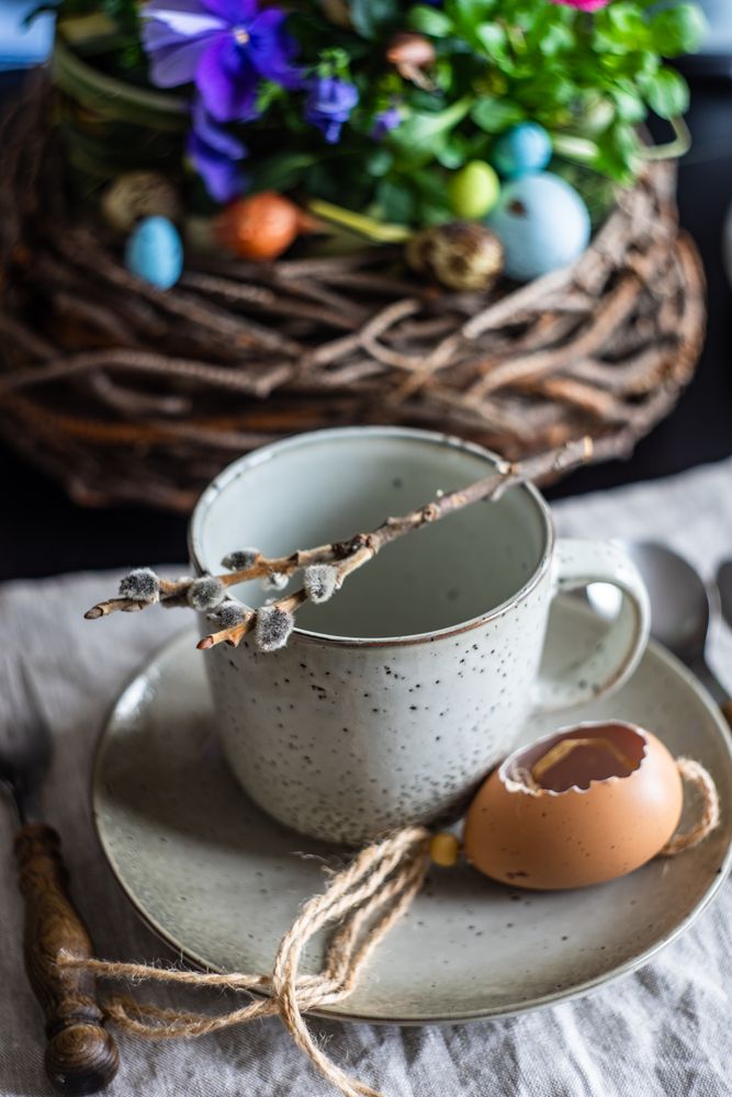 Easter table setting with mug, pussy willow decorative egg shell