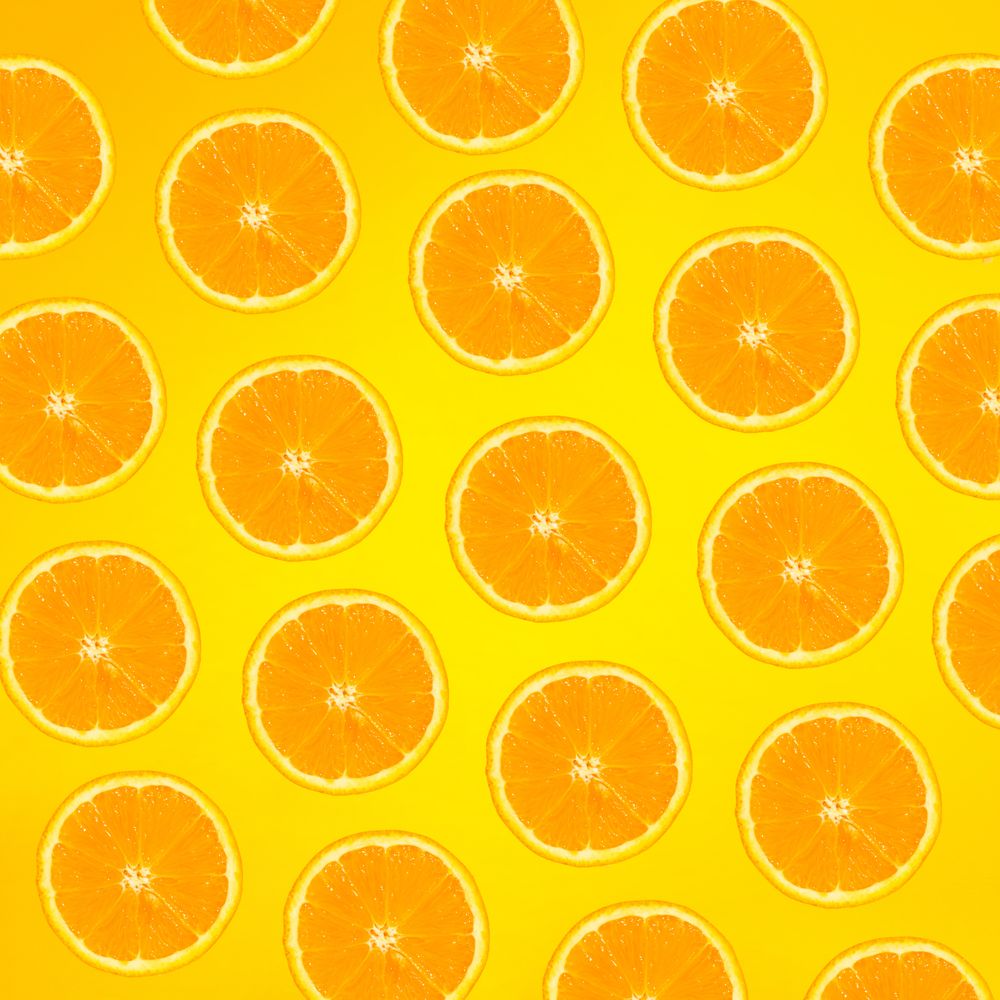 Pattern of orange slices on yellow background