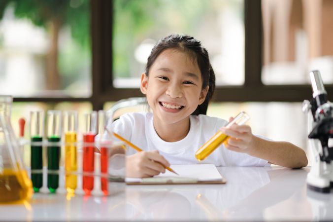 Asian girls having fun experimenting with science.