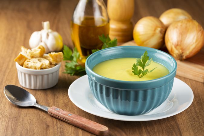 Bowl with onion soup and croutons on the table.