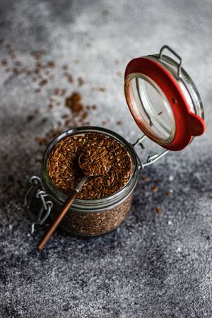 Flax seeds in pot with spoon