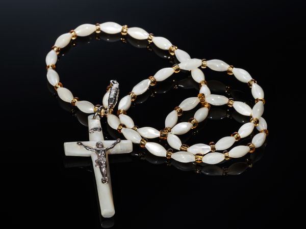 Catholic cross made of silver and mother-of-pearl. Antique jewelry.
