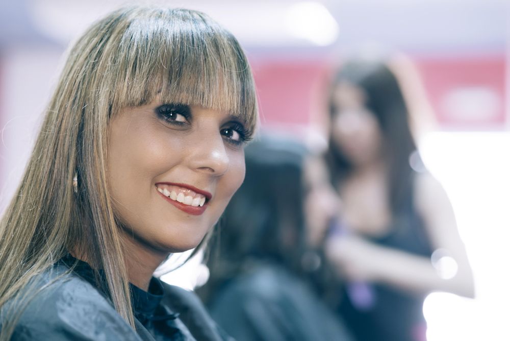 Smiling hair stylist with bangs