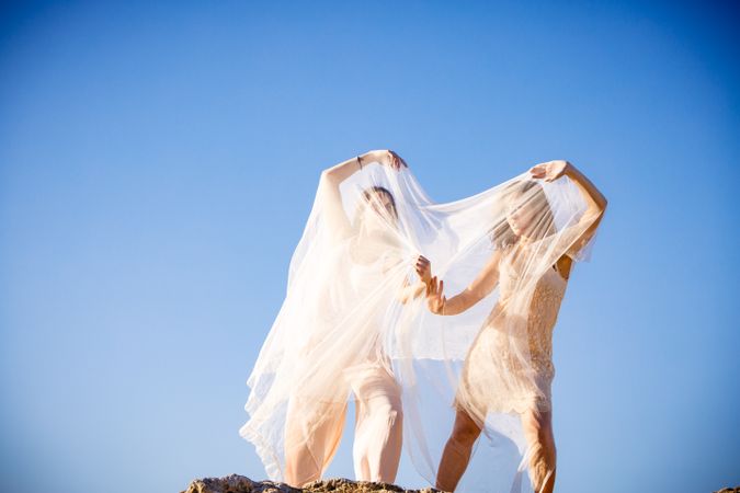 Young women with textile on stone