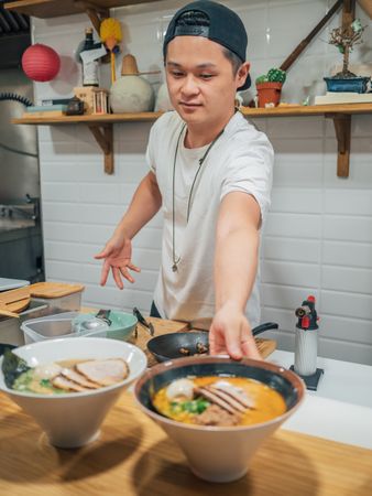 Asian chef with served bowls of ramen