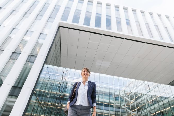 Happy female manager walking from work