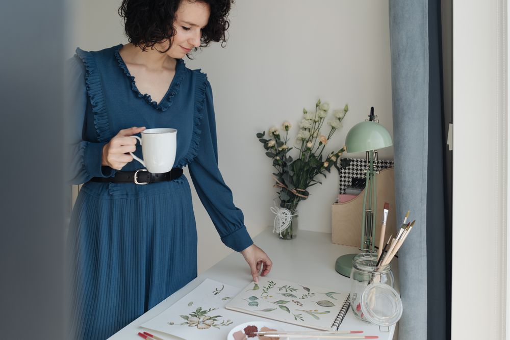 Painter with cup of coffee at work
