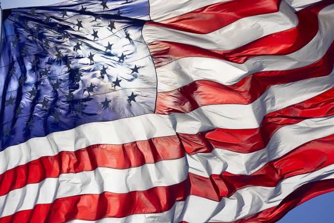 Dramatic Backlit American Flag Waving in the Wind.