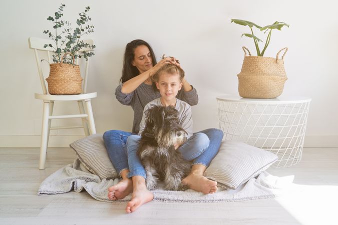 Mother doing hairstyle to son
