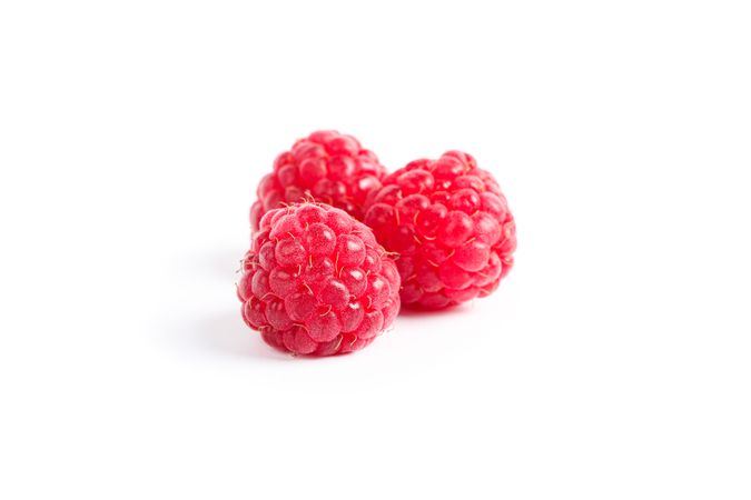 Fresh sweet raspberries isolated on blank background