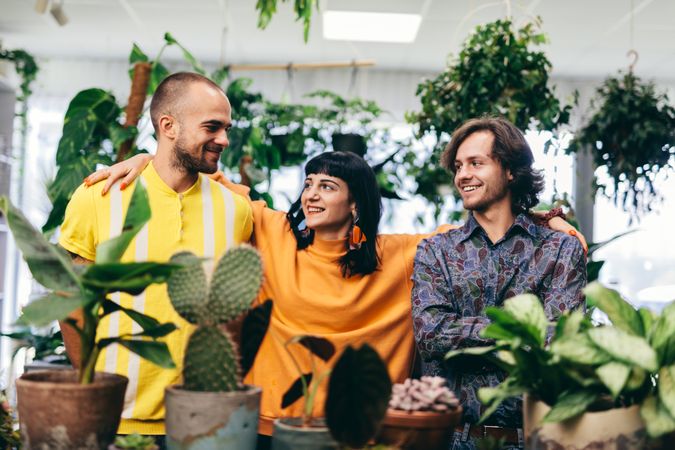 Woman and two men in the flower shop.