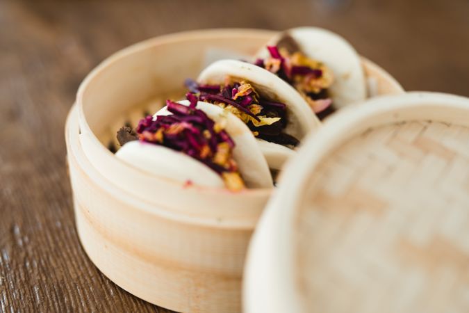 Traditional Asian steamed buns in bamboo steamer