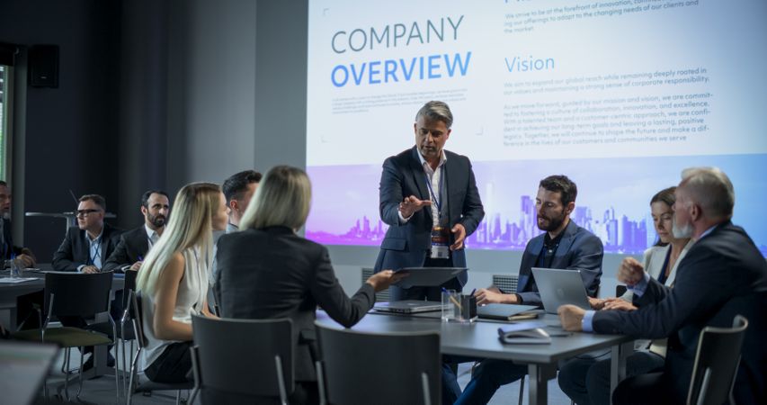 Corporate Event: Male Tech CEO Hosting Team Building Workshop With Diverse Employees In Conference Room Of Innovative Startup Company Office.