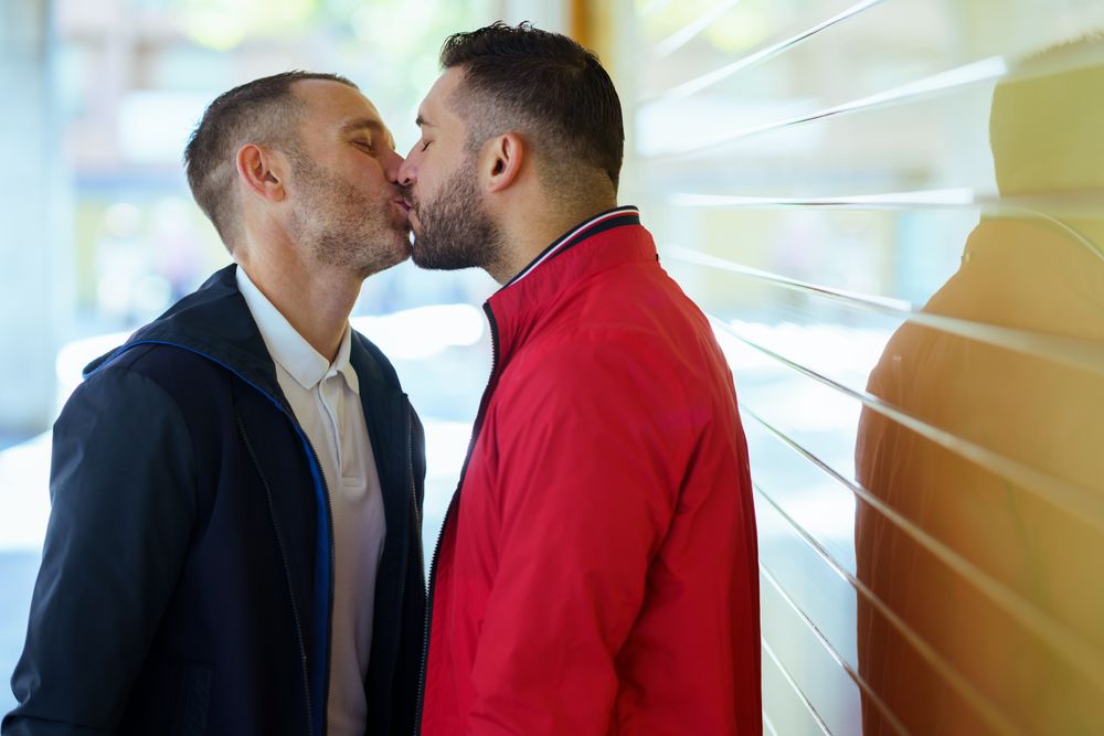 Gay couple kissing on the street