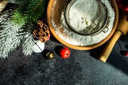 Top view of flour and ingredients on dark counter