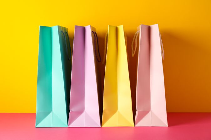 Color paper bags on multicolor background, space for text