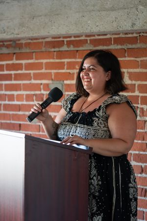 Woman enjoying public speaking at the podium with a microphone