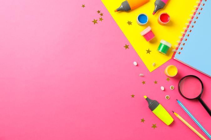Flat lay composition with school supplies on two tone background, space for text