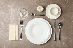 Composition of table setting with cutlery on gray background