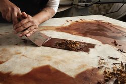 Man working with scraper and chocolate