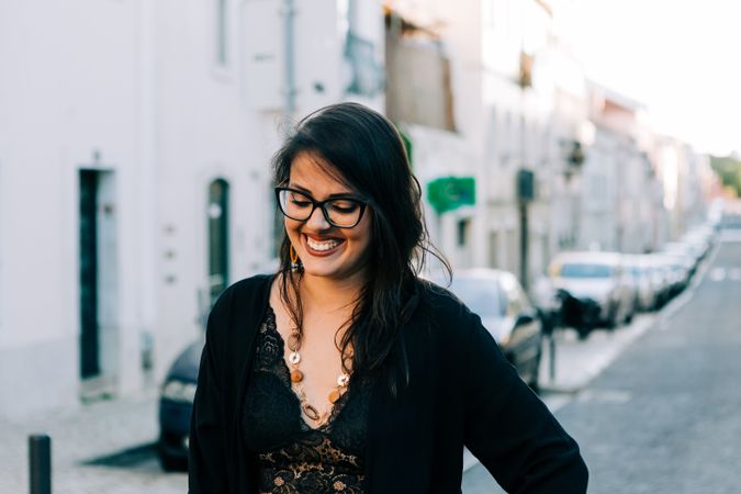 Joyful trendy female in old town street