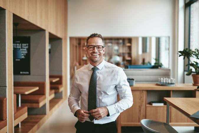 Portrait of smiling business standing in an open office