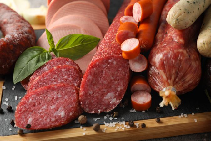 Close up of cured meat sticks on kitchen board