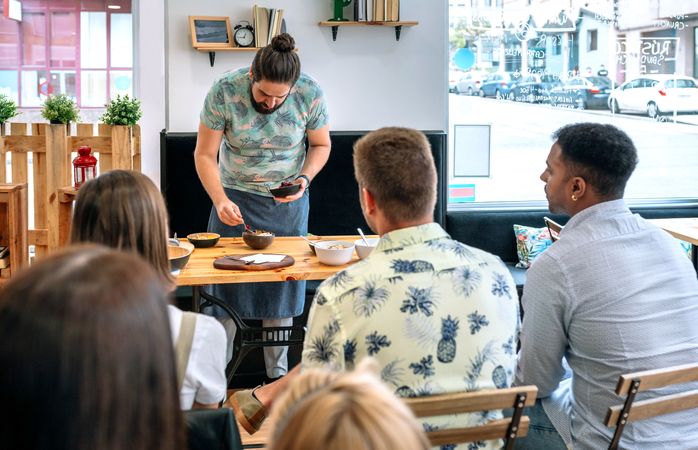 Young cook giving a cooking workshop